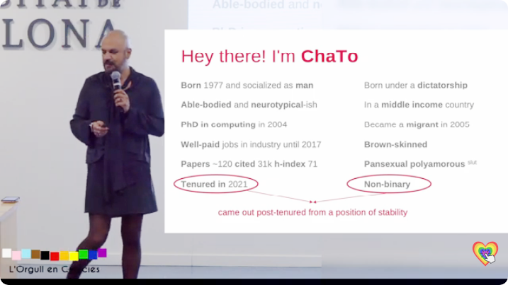 ChaTo offering a talk in front of a screen